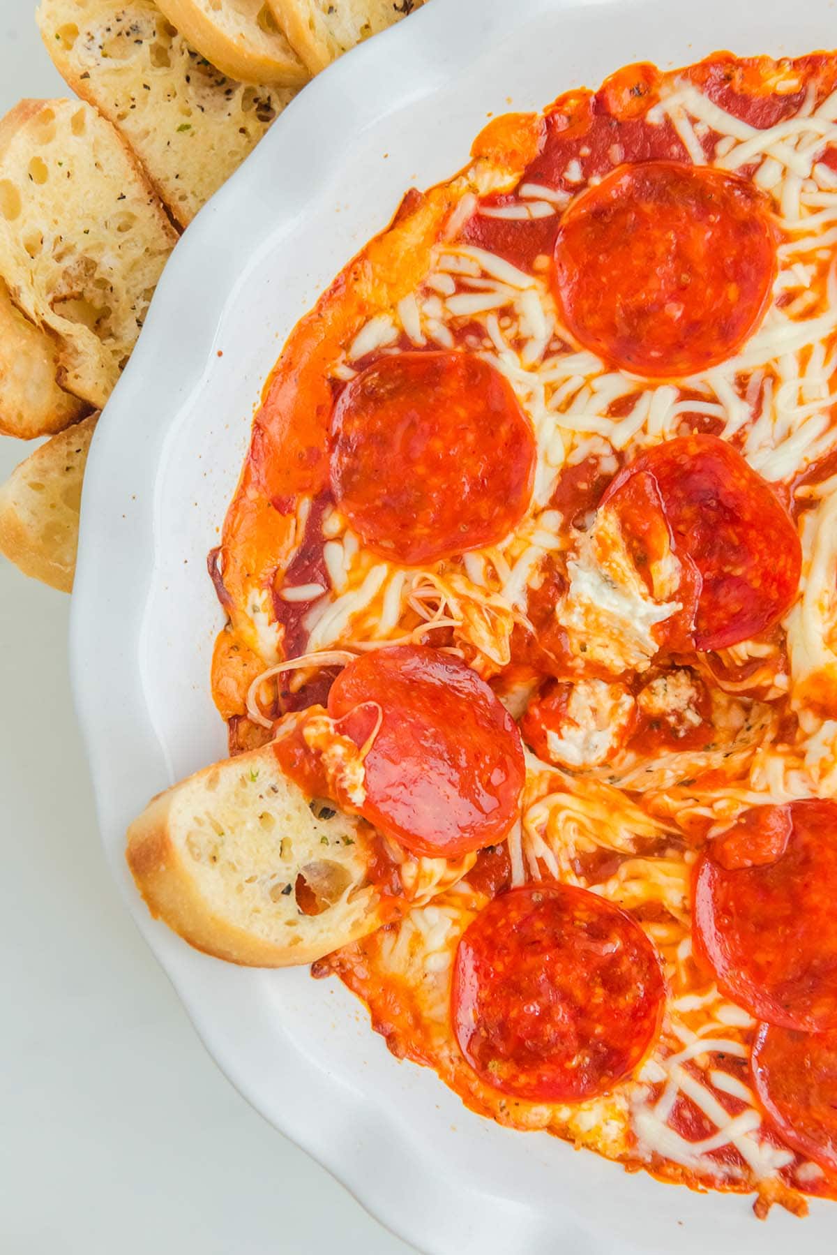 Cheese Pizza Dip with a couple slices of garlic bread on the side.