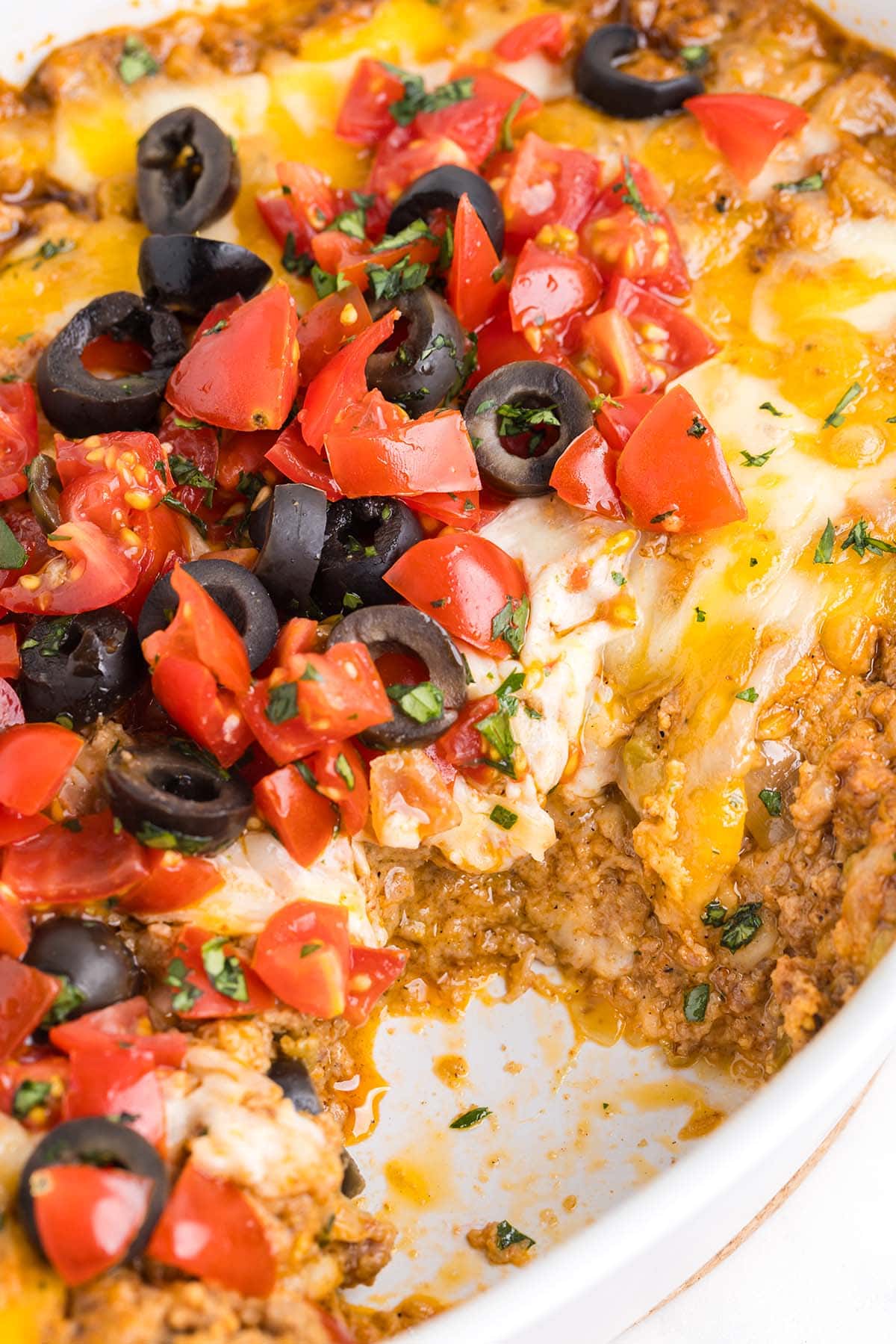 cheesy taco dip topped with black olives.