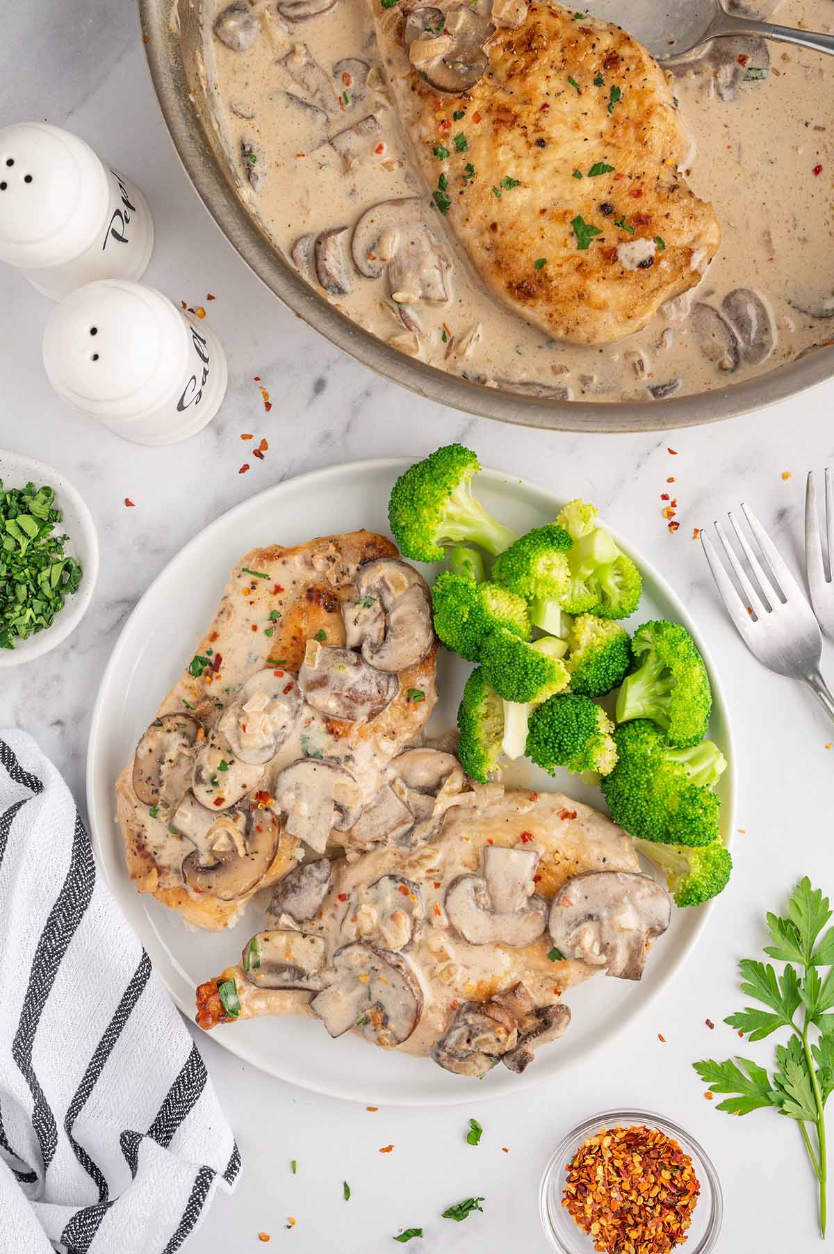 Easy Chicken Marsala served on a plate with broccoli on the side.