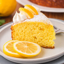 a slice of Lemon Ricotta Cake on a white plate.