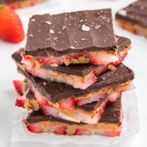 a couple of Strawberry Peanut Butter Bark stacked on a white table.
