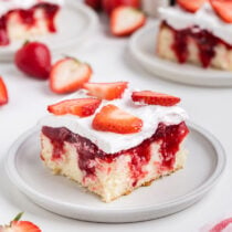 Strawberry Shortcake Poke Cake with strawberries toppings.