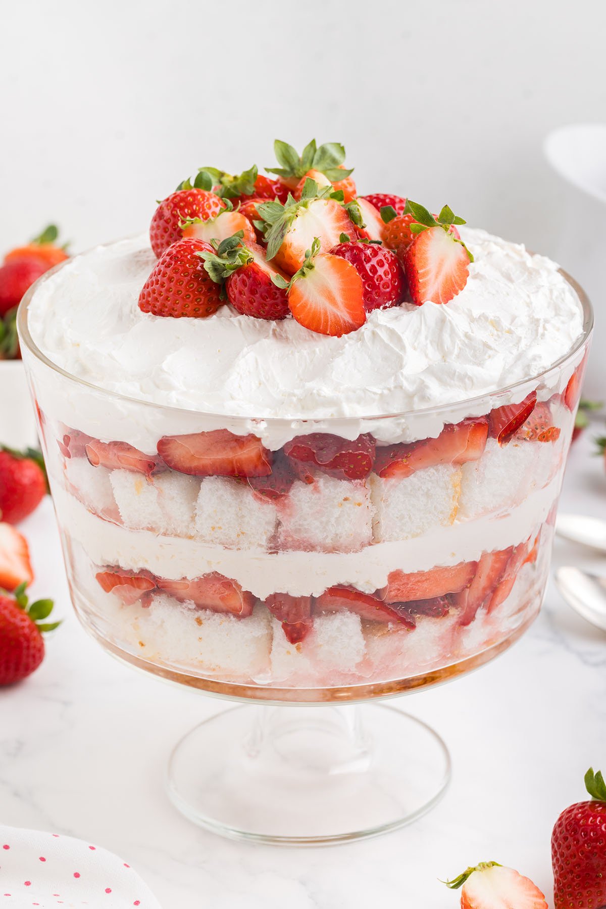 strawberry shortcake trifle with fresh strawberries on top.