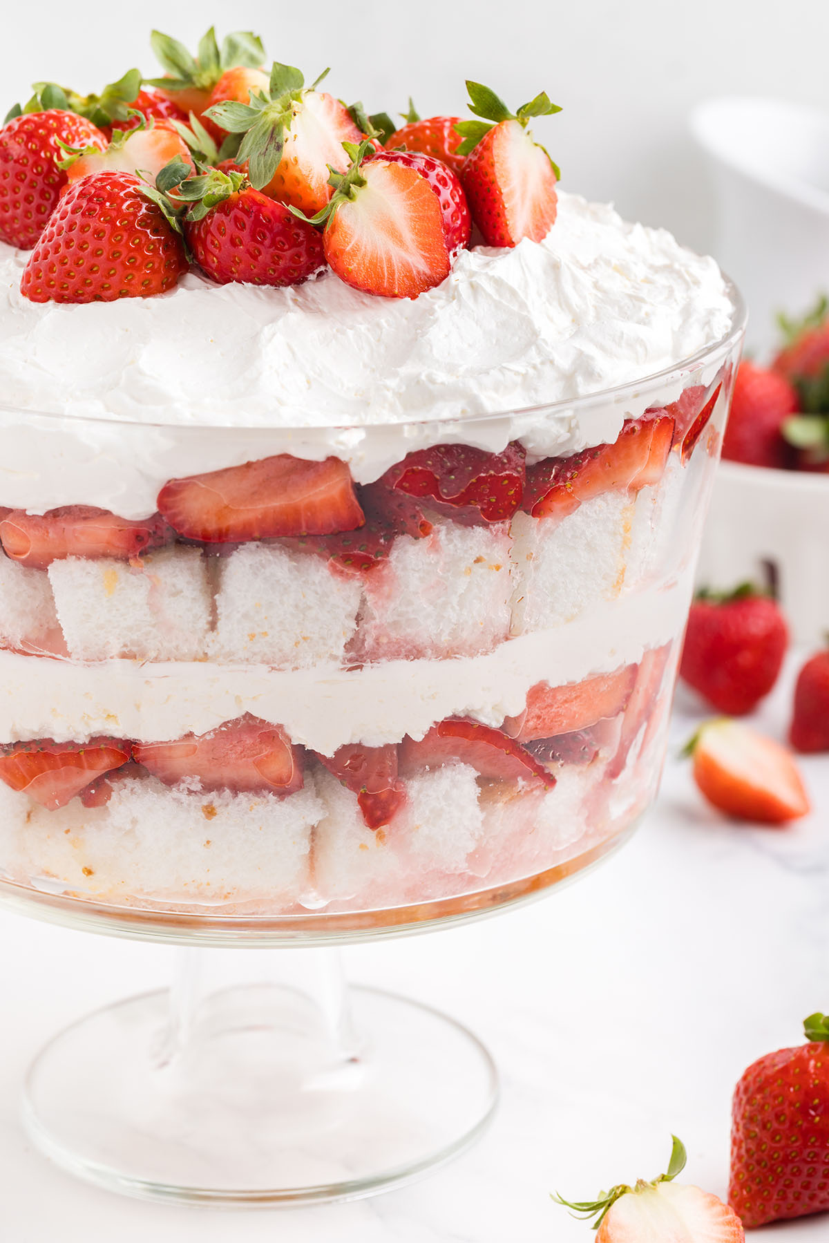 strawberry shortcake trifle with layers of cake, strawberries and cream cheese.