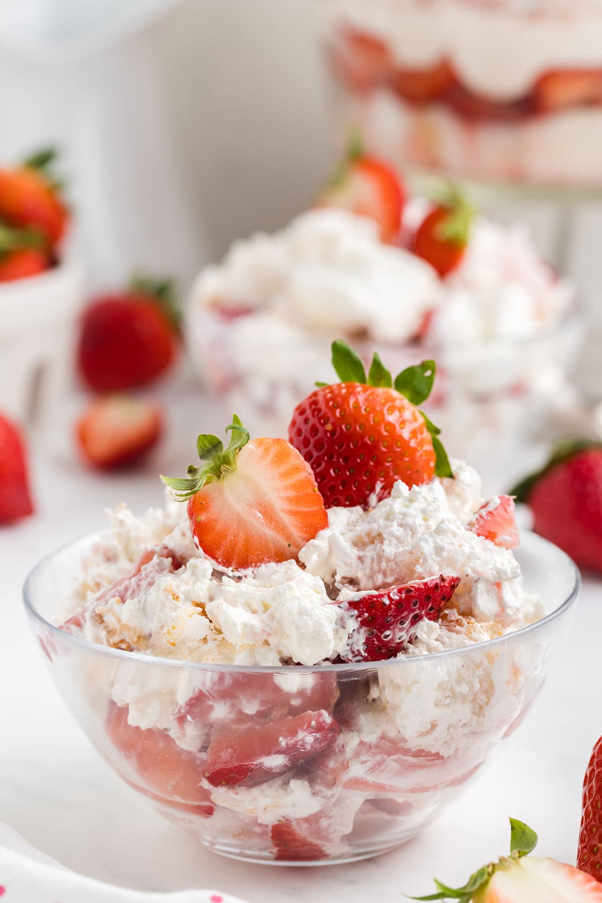 serving strawberry shortcake trifle in a bowl.