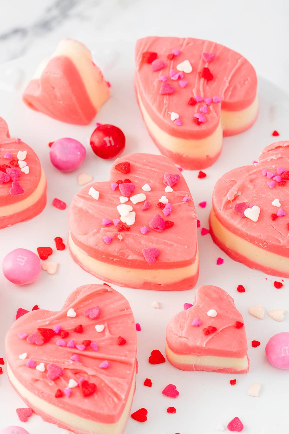 a couple of Valentine Hearts Fudge on a white table.