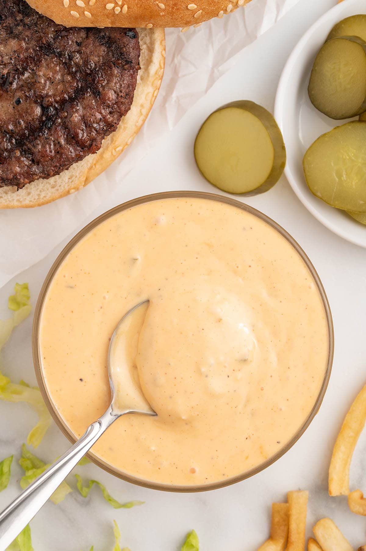 big mac sauce in a bowl with pickles on the side.
