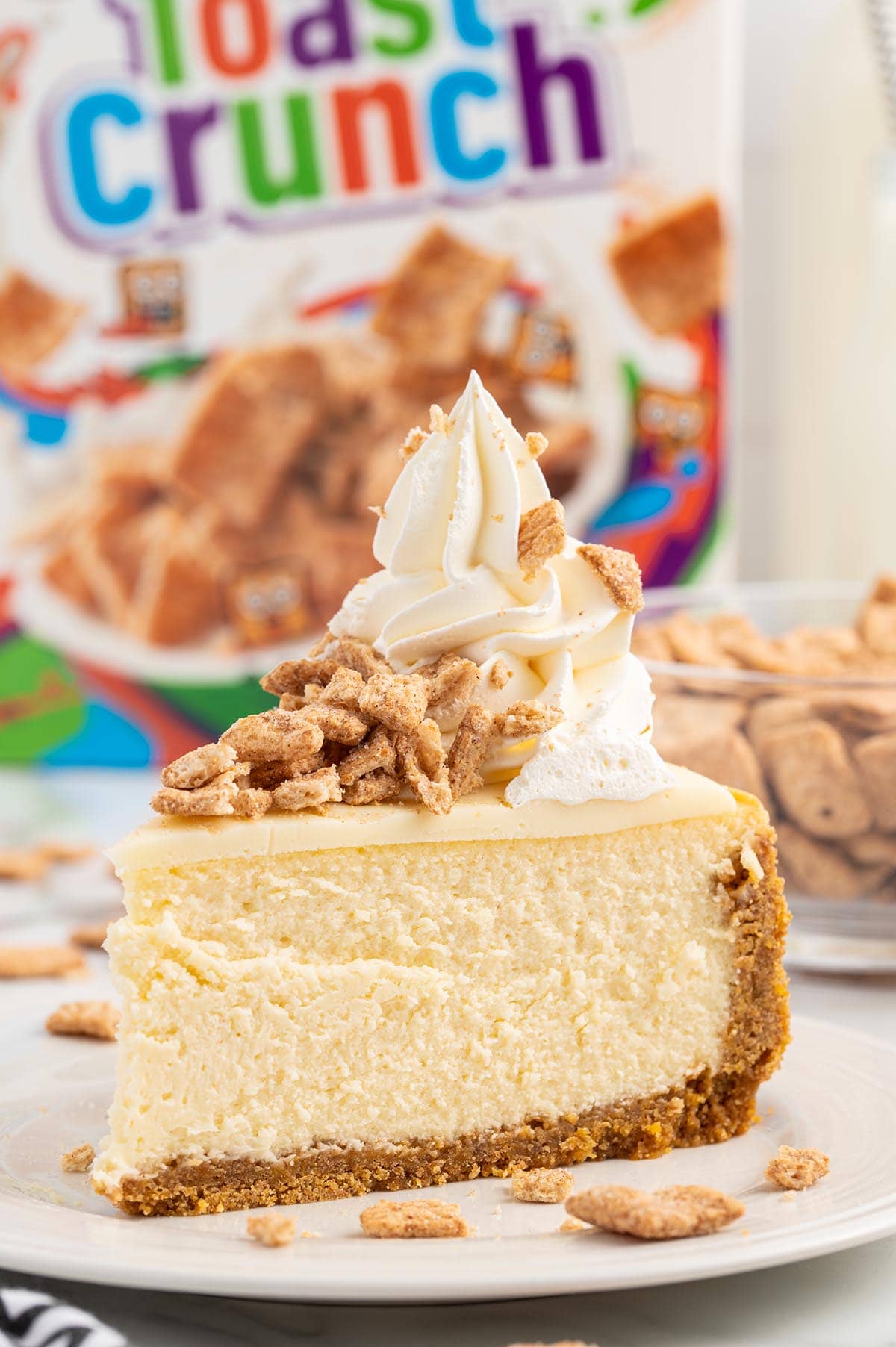 one slice of Cinnamon Toast Crunch Cheesecake on a plate.