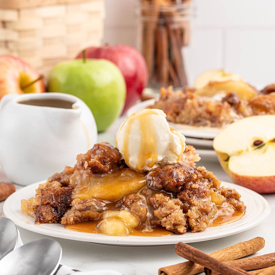 Snickerdoodle Cobbler served with ice cream on a plate.