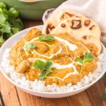 Indian Butter Chicken served with a bowl of rice.