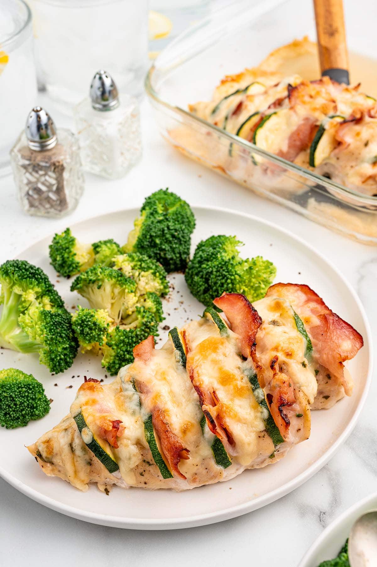 Hasselback Chicken served with broccoli on the side.