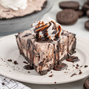 Ice Cream Pie with whipped topping and chocolate sauce.