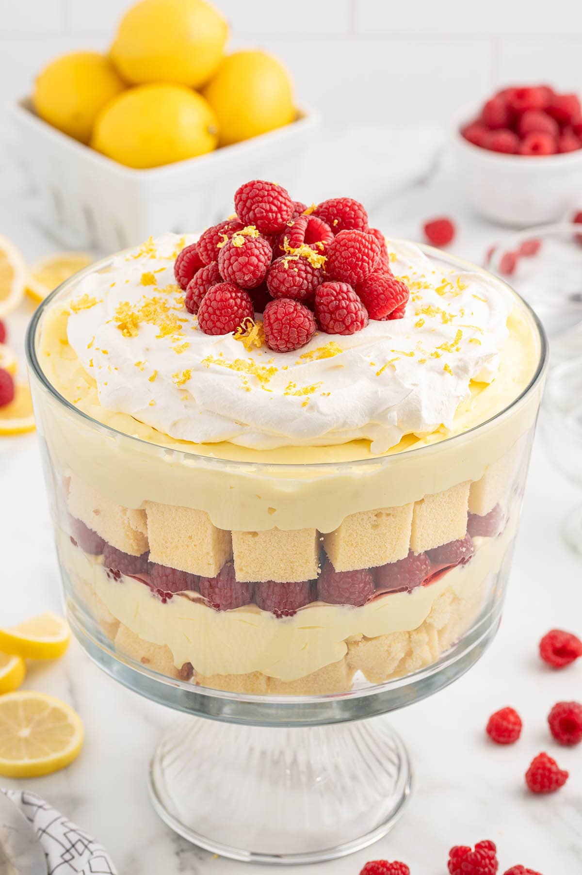 Lemon Raspberry Trifle in a trifle bowl topped with fresh raspberries.