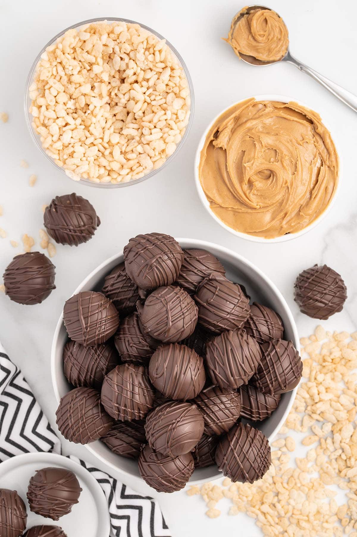 peanut butter balls coated with melted chocolate in a bowl.