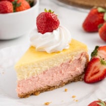 Strawberries and Cream Cheesecake on a white plate.