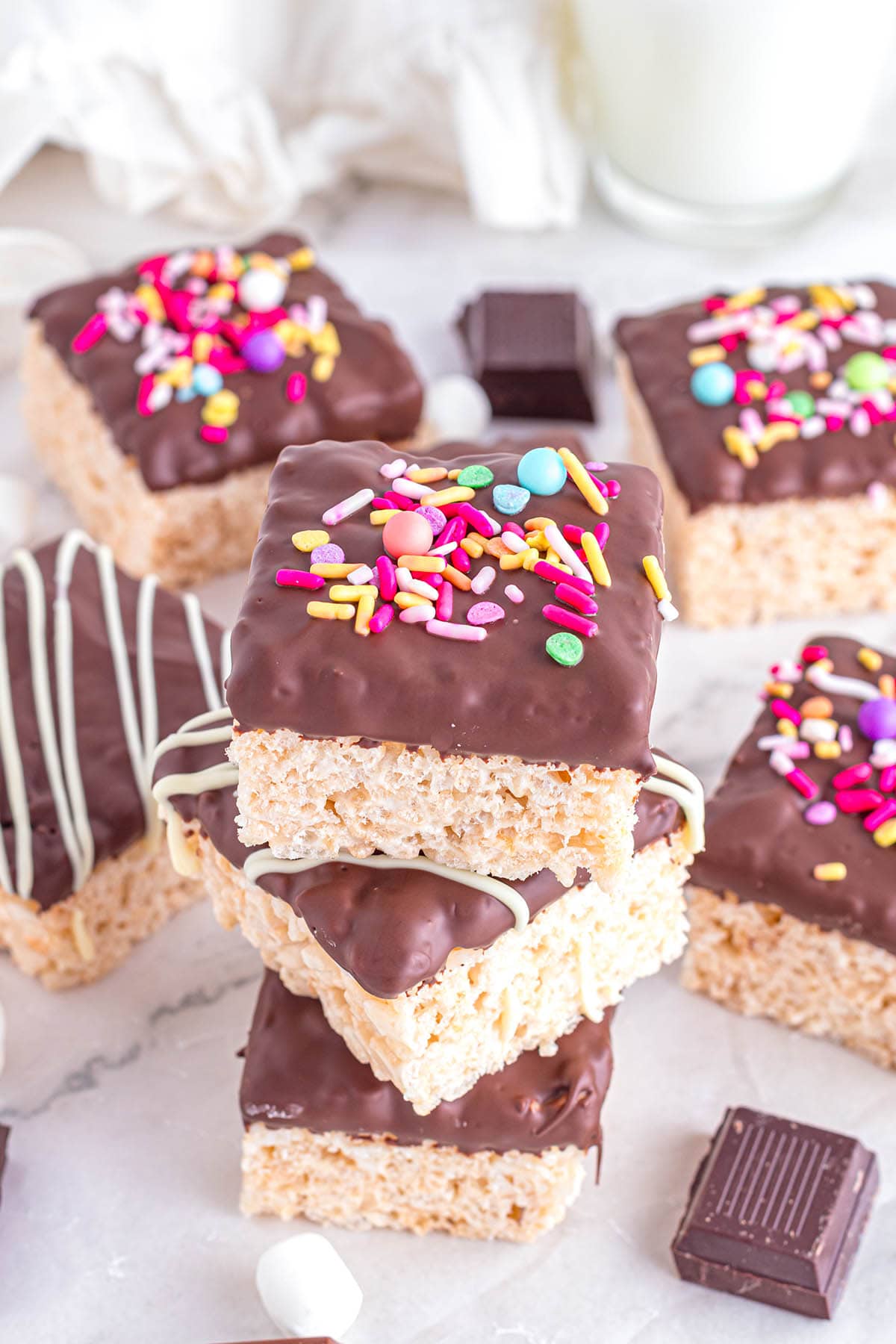 a couple of stacked Chocolate Dipped Rice Krispie Treats on the table.