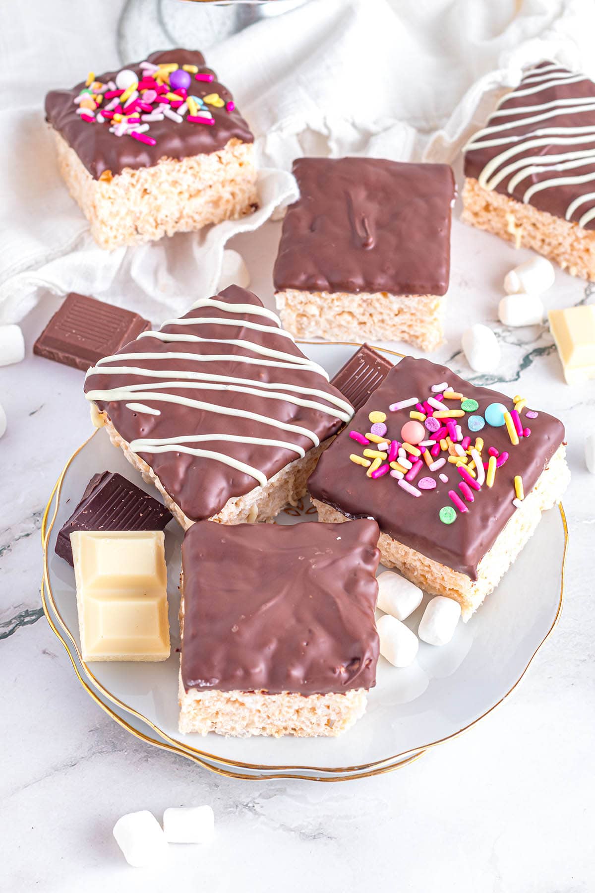 3 pieces of Chocolate Dipped Rice Krispie Treats on a plate.