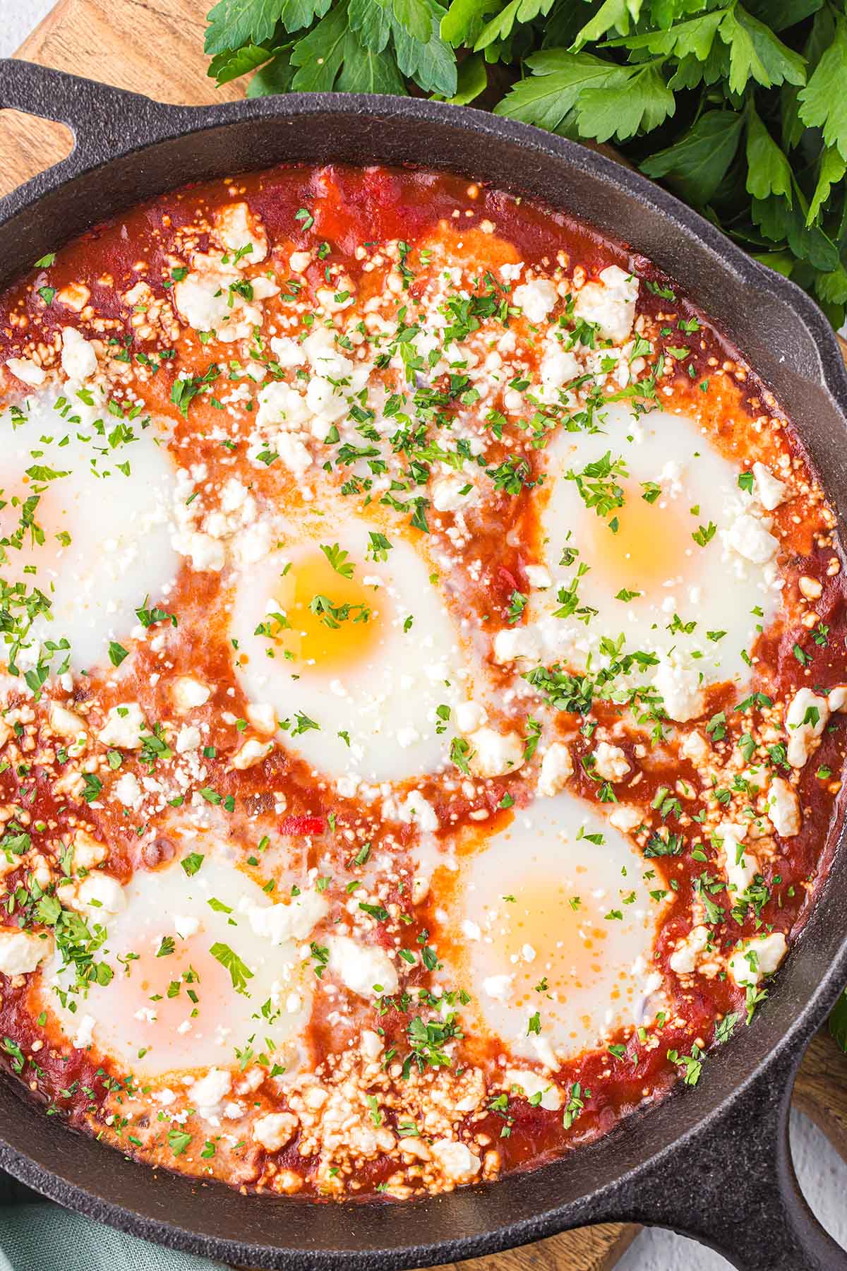 Shakshuka garnished with feta cheese and cilantro on top.