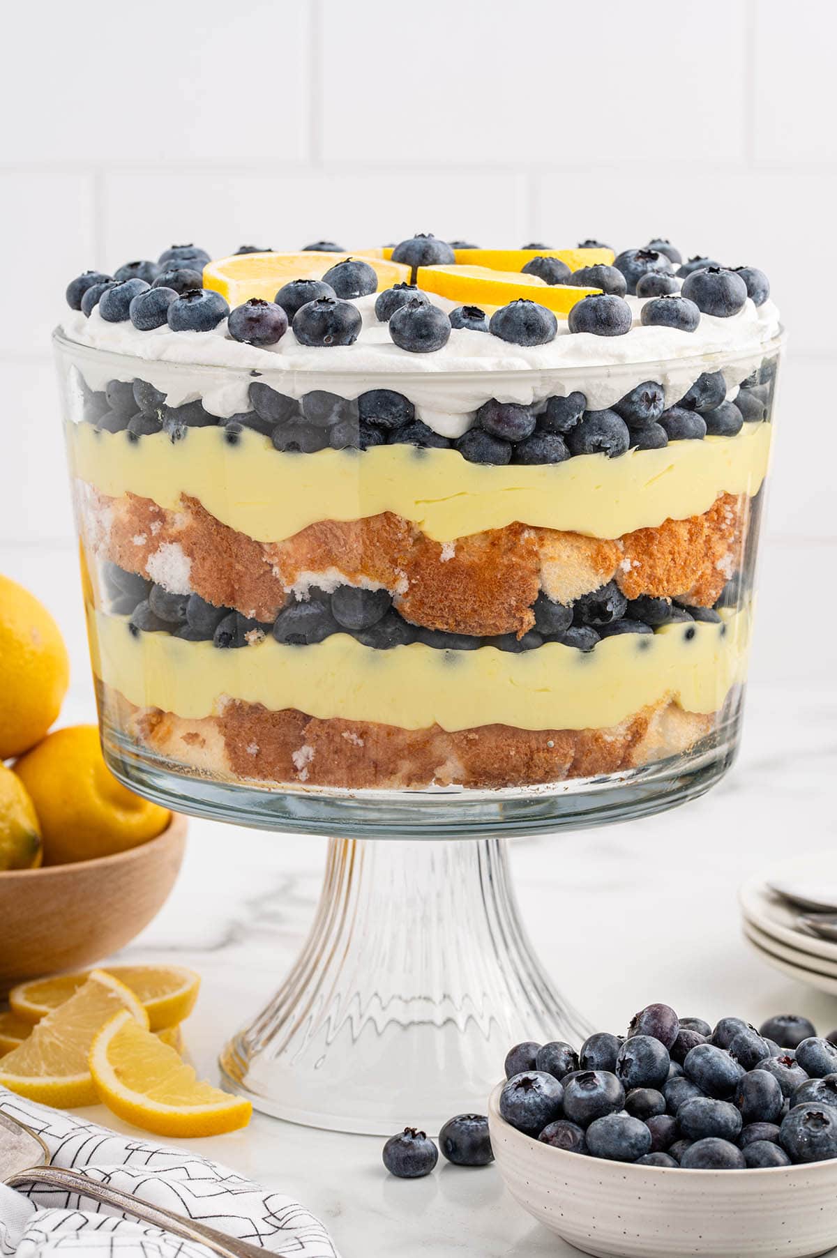 Lemon Blueberry Trifle with a couple of blueberries in the bowl on the side.
