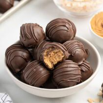 peanut butter balls with rice krispies in the white bowl.