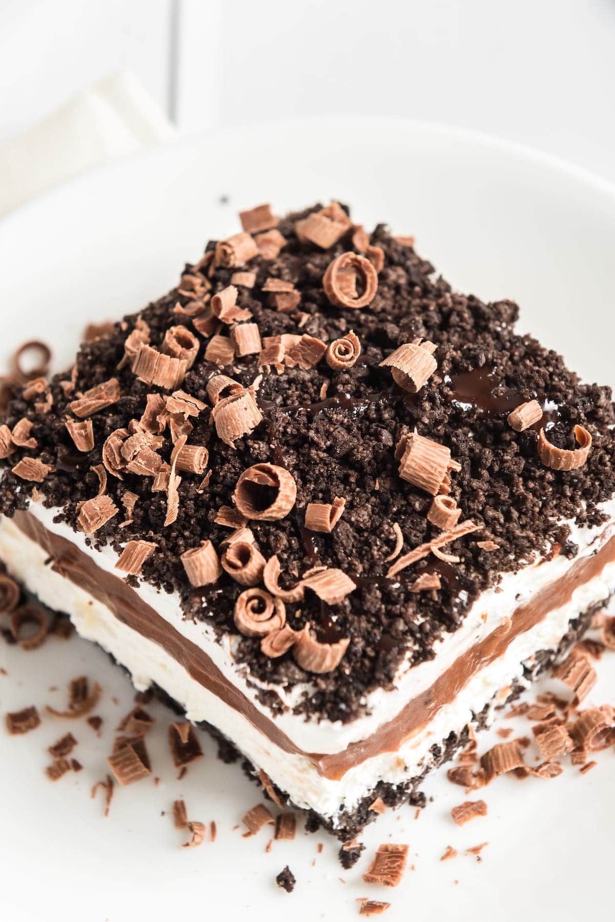 a slice of chocolate lasagna with chocolate shavings on top.