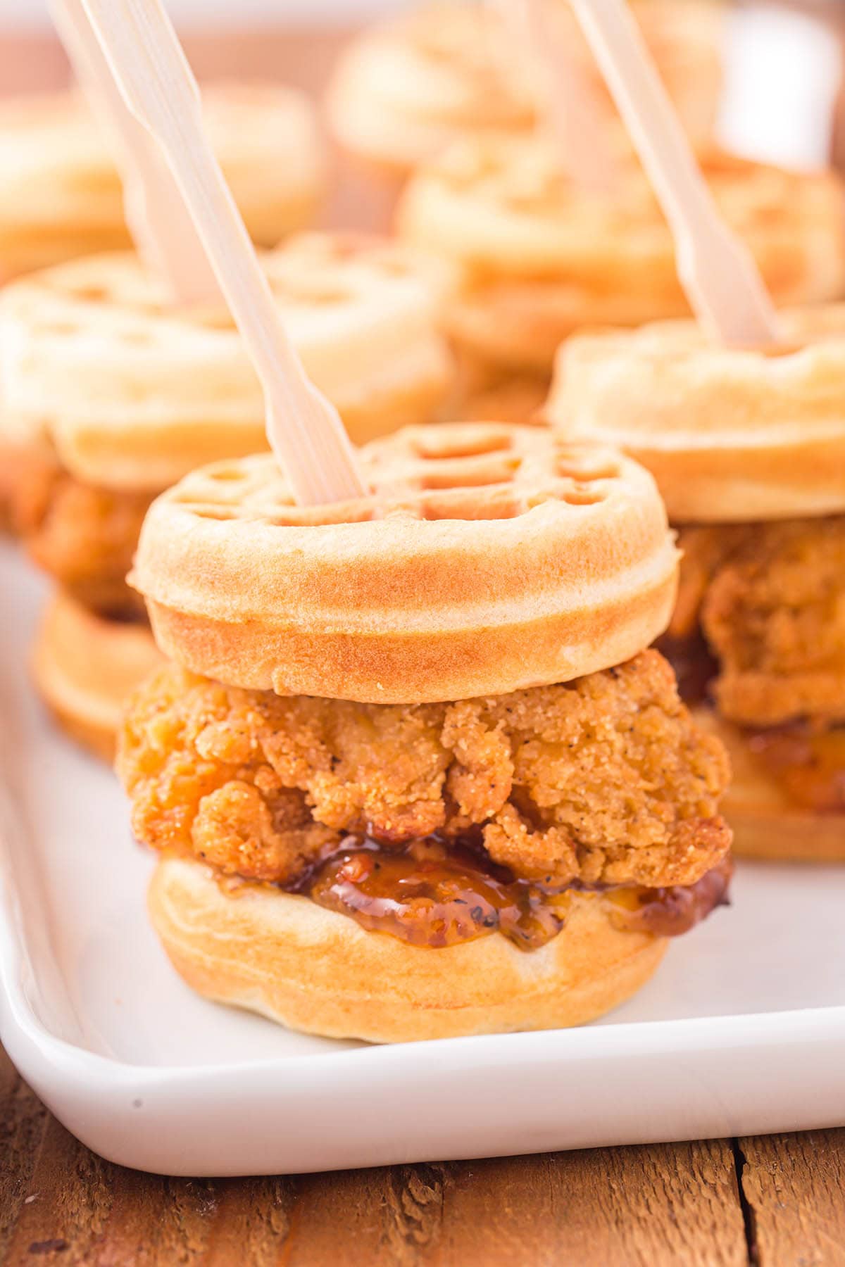 a couple of Chicken and Waffle Sliders on a white plate.