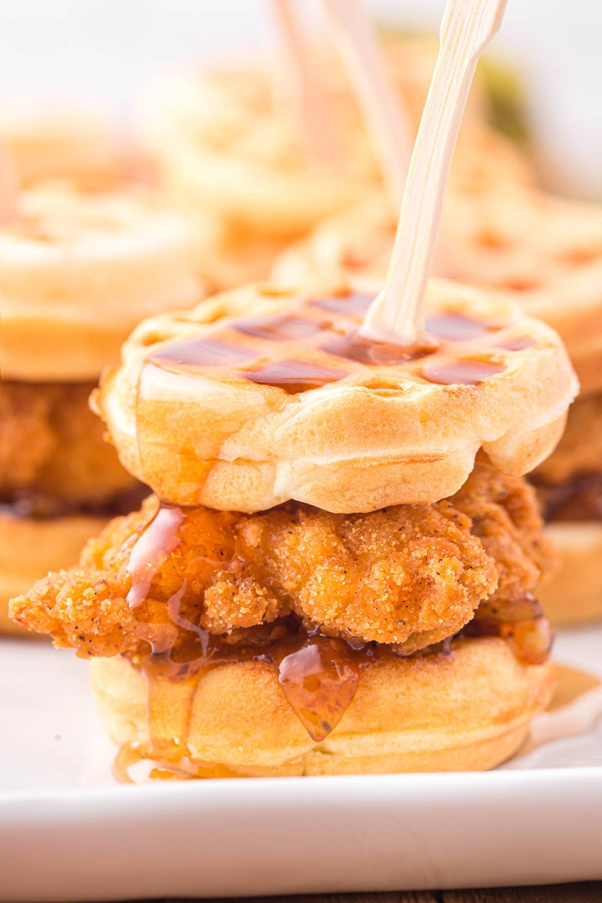 Chicken and Waffle Sliders drizzled with maple syrup.
