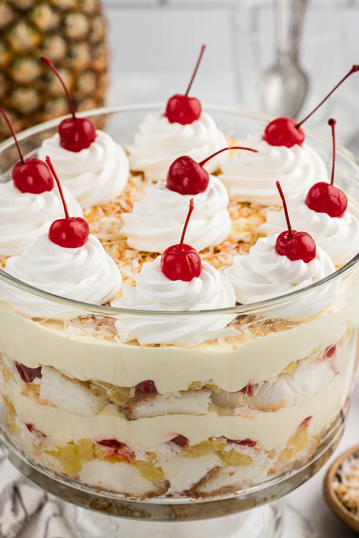 Pina Colada Trifle topped with cool whip dollops and cherries.