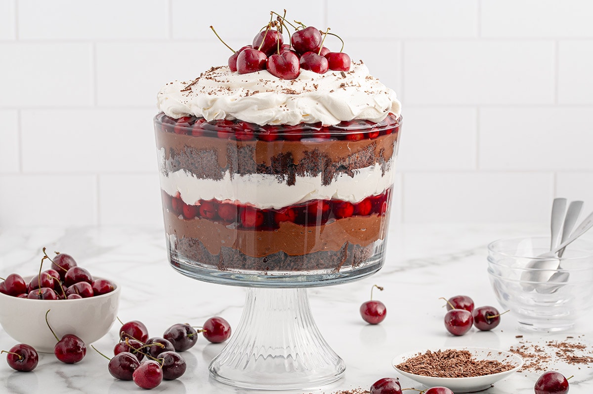 Black Forest Trifle garnished with whipped topping and cherries.