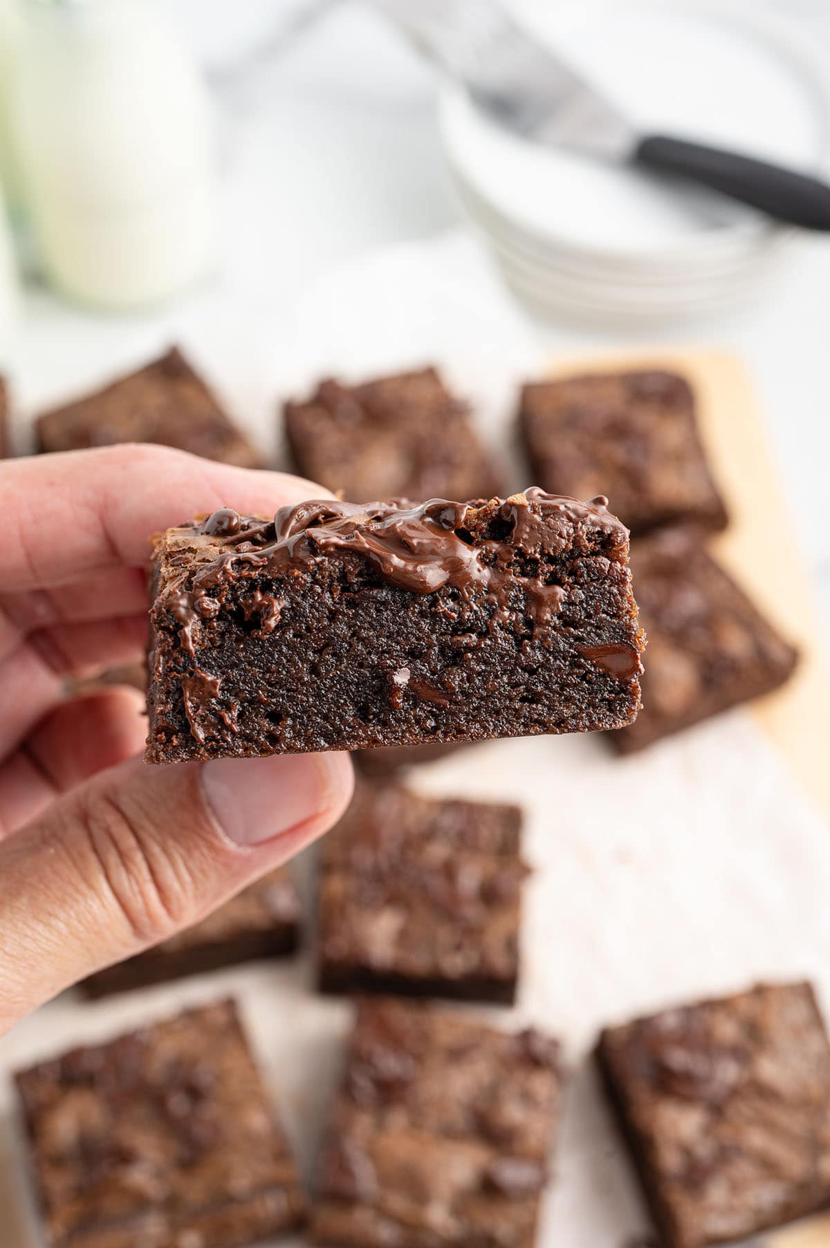 hand holding a fudgy brownie. 