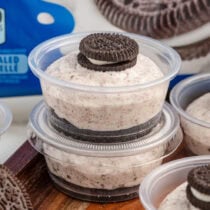 Oreo Dessert Cups stacked on top of wooden board.