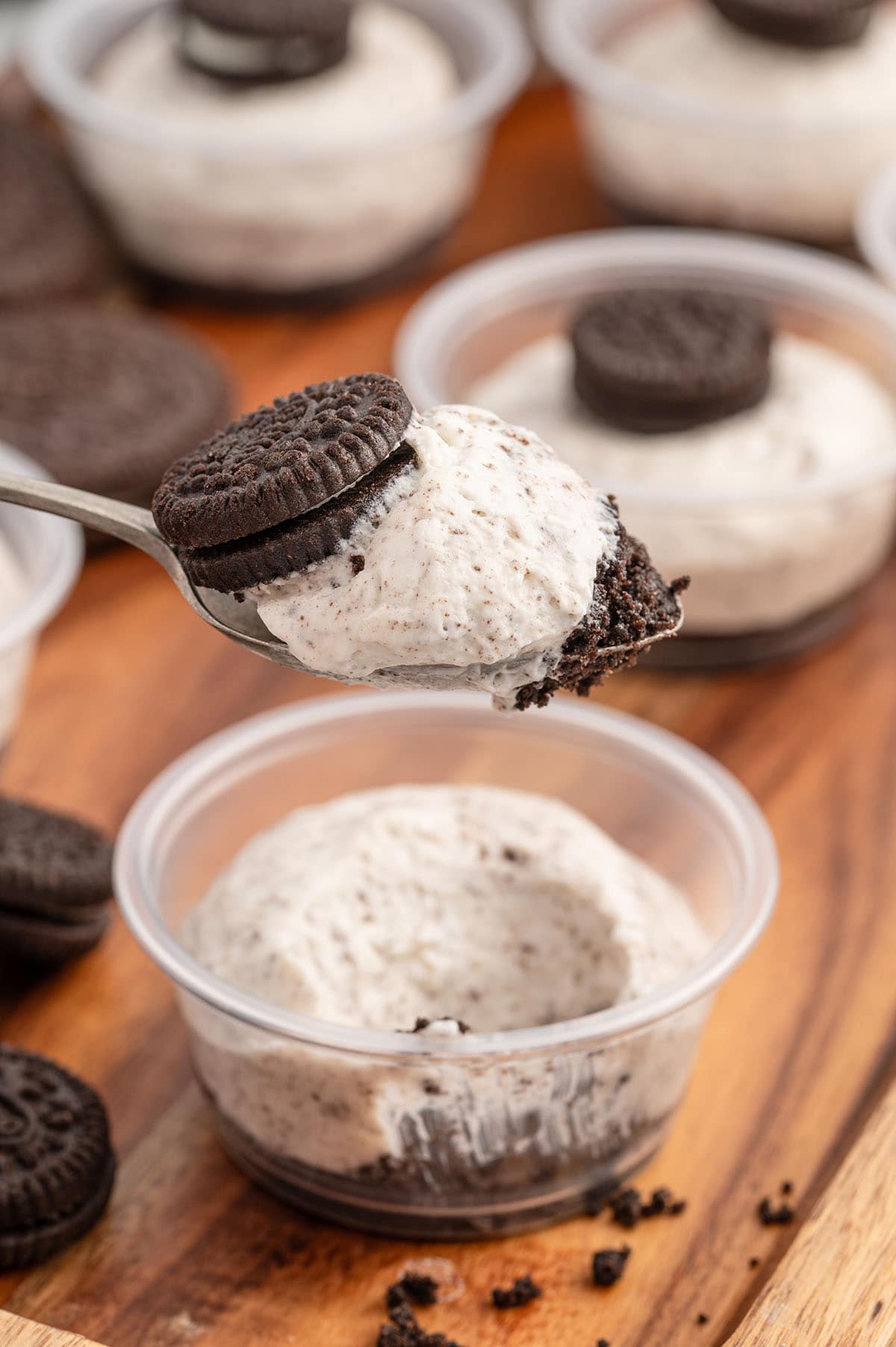 a spoonful of oreo desserts in a cup. 