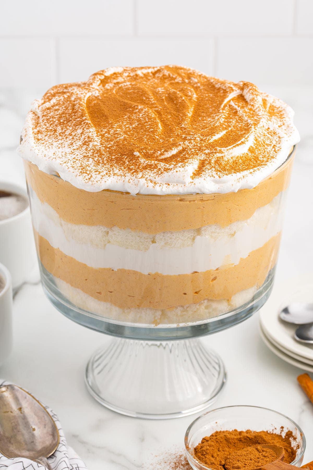 4-layer Pumpkin Trifle in a trifle bowl with whipped topping and pumpkin spice.