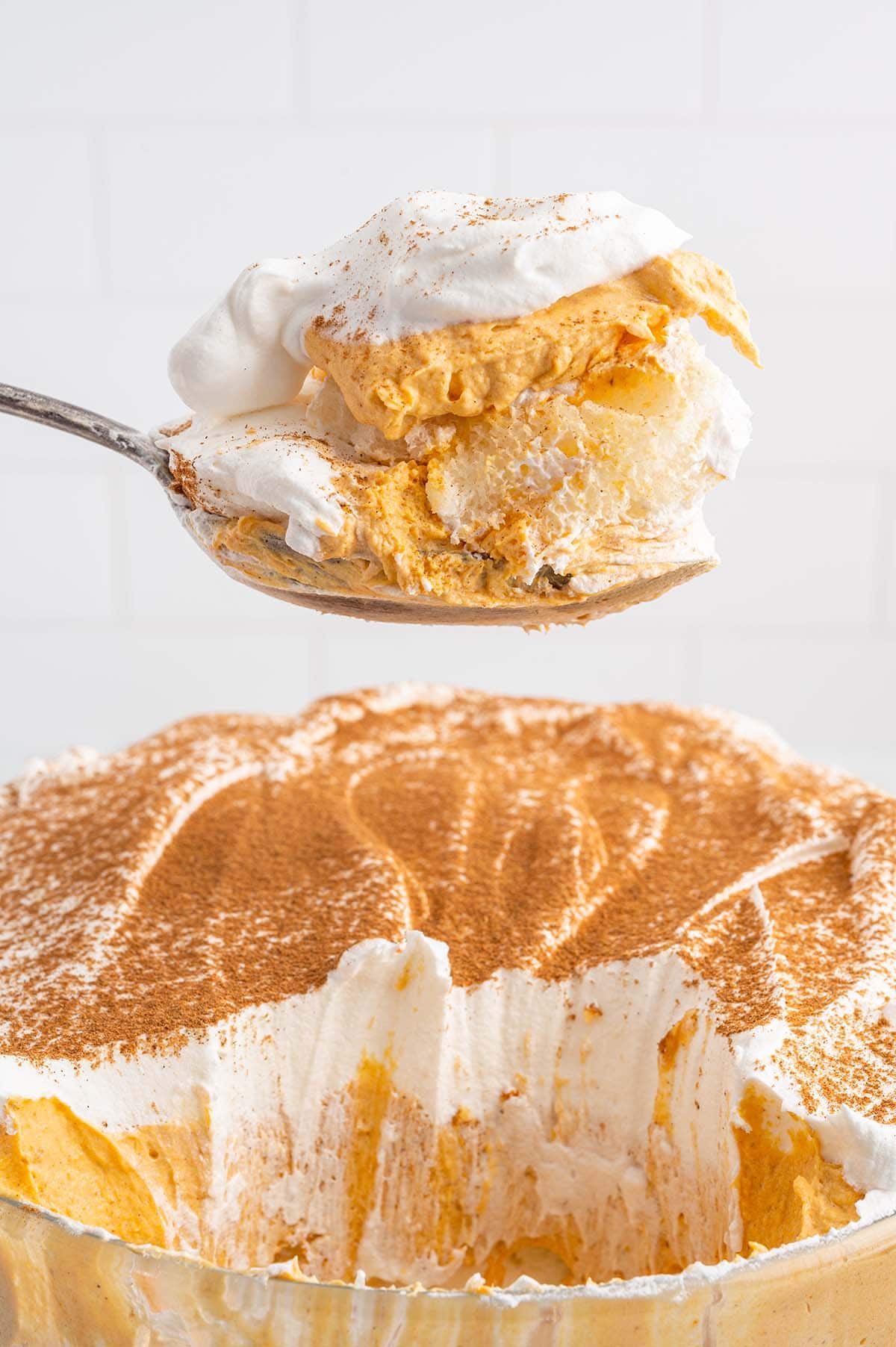 a spoonful of Pumpkin Trifle with whipped topping.