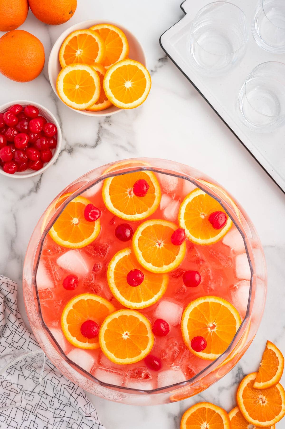 shirley temple punch with  orange slices and cherries on the side.