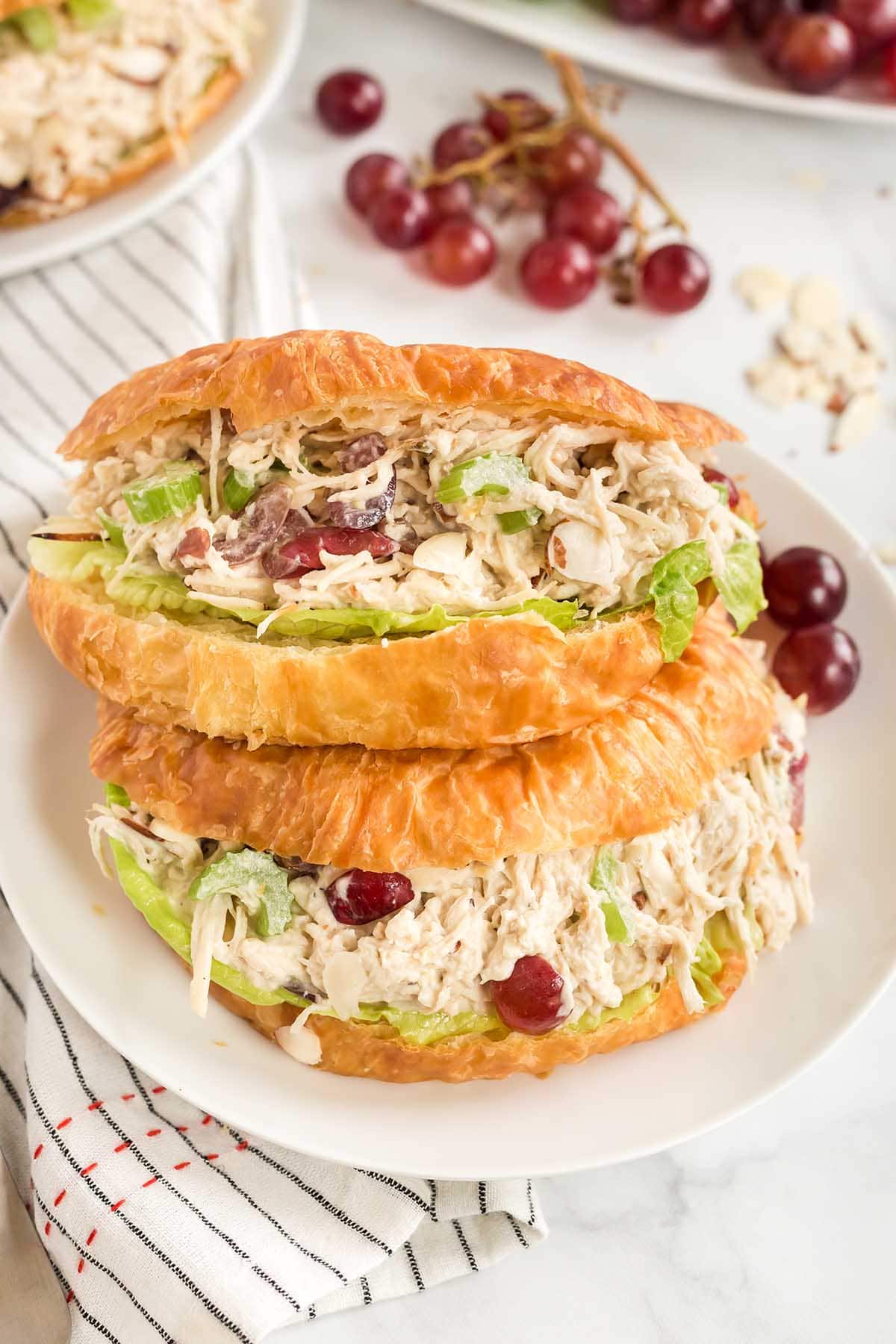 a sandwich made with golden brown croissant filled with Chicken Salad.