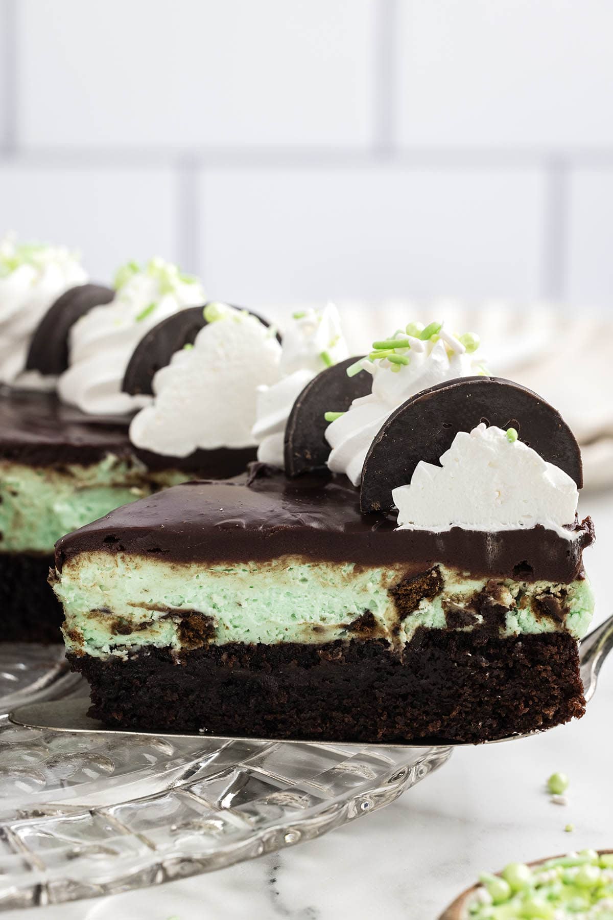 cutting a slice of thin mint cheesecake. 