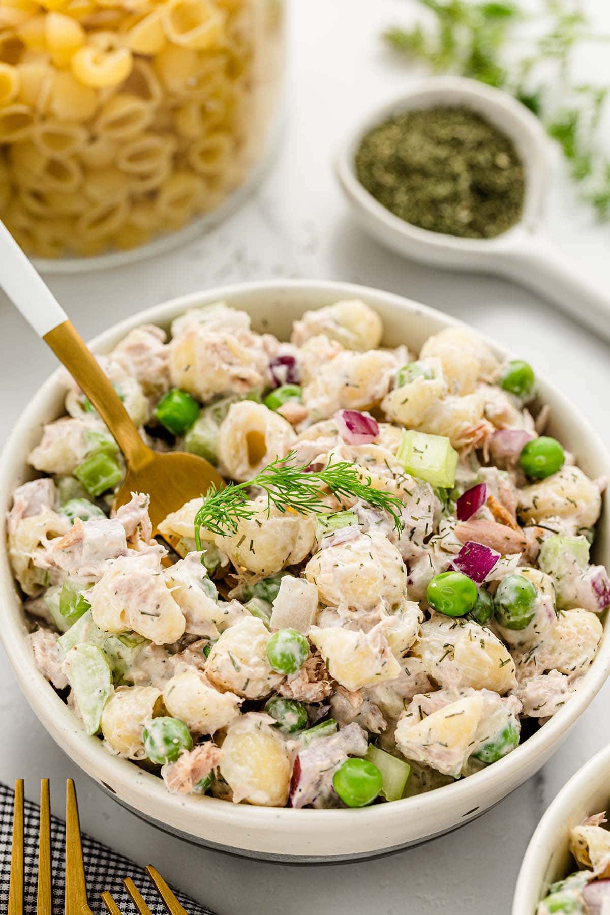 Tuna Pasta Salad with dried dill served in a white bowl.