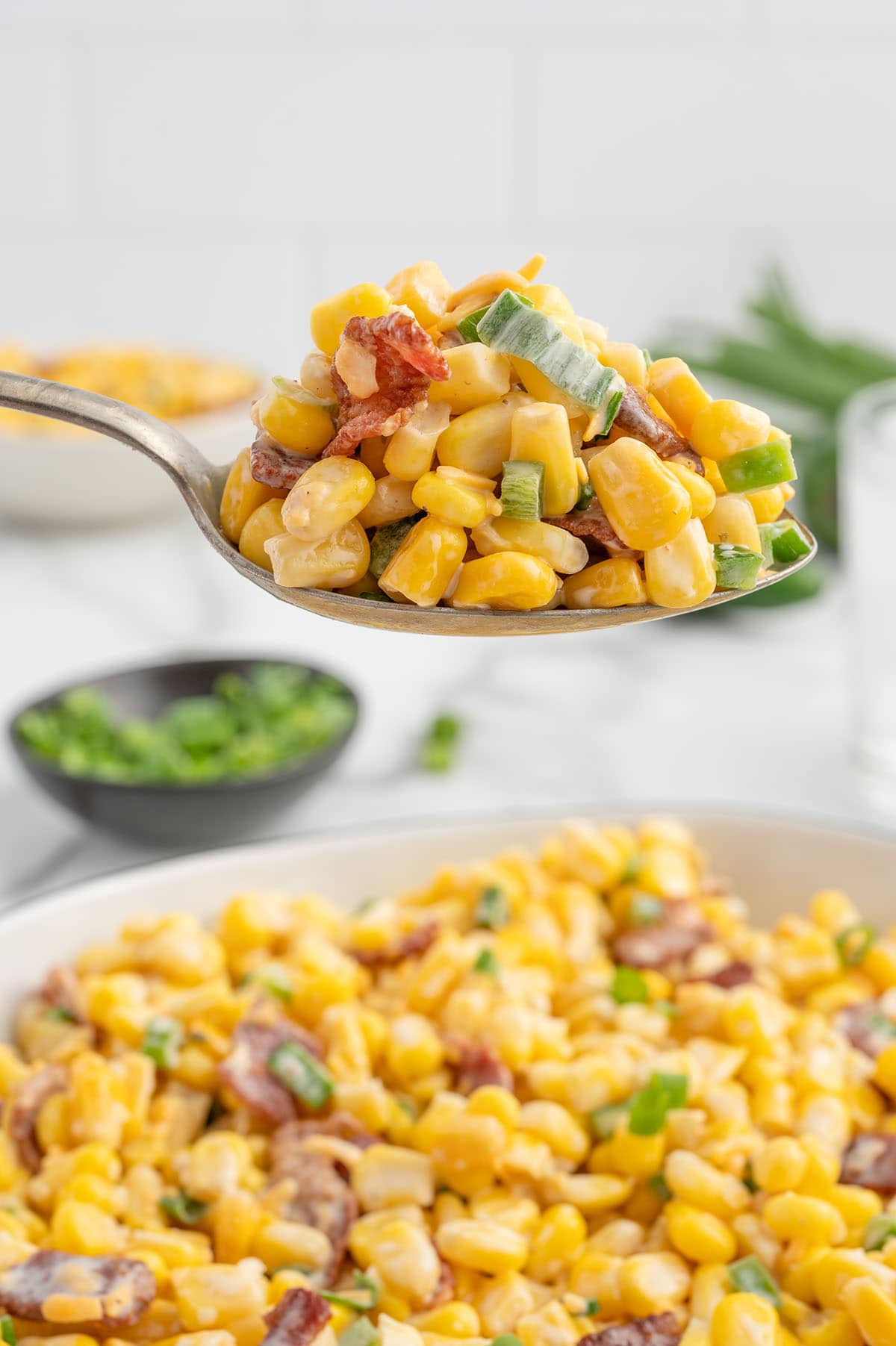 a spoonful of Crack Corn Salad with green onions and bacon.