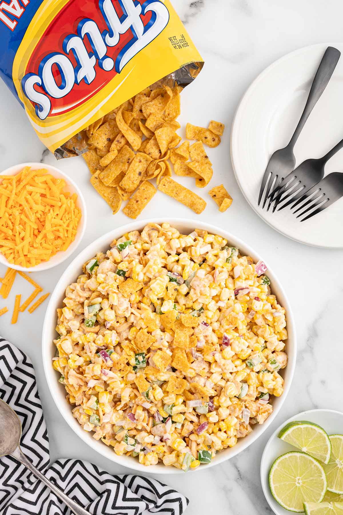 fritos corn salad in a bowl with a bag of fritos on the side. 