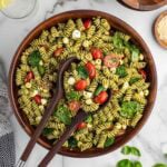 pesto pasta salad in a wooden bowl.