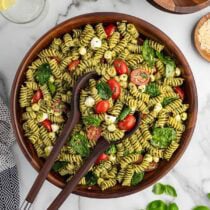 pesto pasta salad in a wooden bowl.