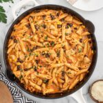 A skillet of Southwest Chicken Pasta garnished with parsley.