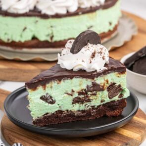 a slice of thin mint cheesecake on a black plate.