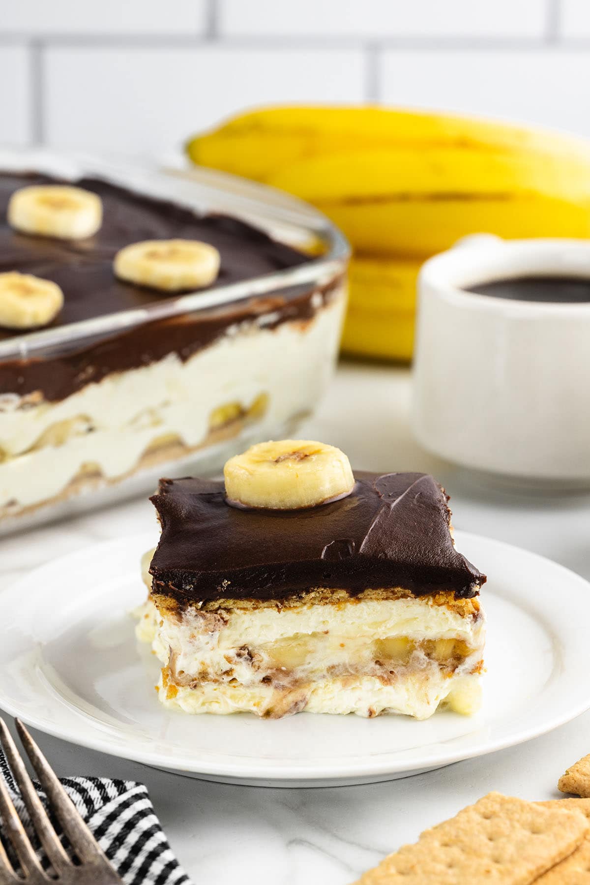 a slice of Banana Eclair Cake on a white plate.