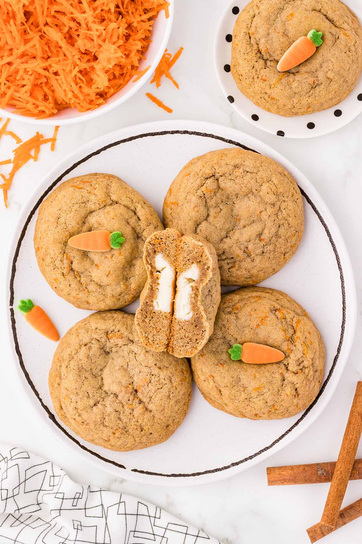 a couple of Carrot Cake Stuffed Cookies on a white plate.