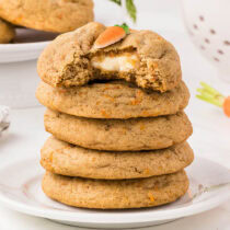 a couple of Carrot Cake Stuffed Cookies stacked up on a large plate.