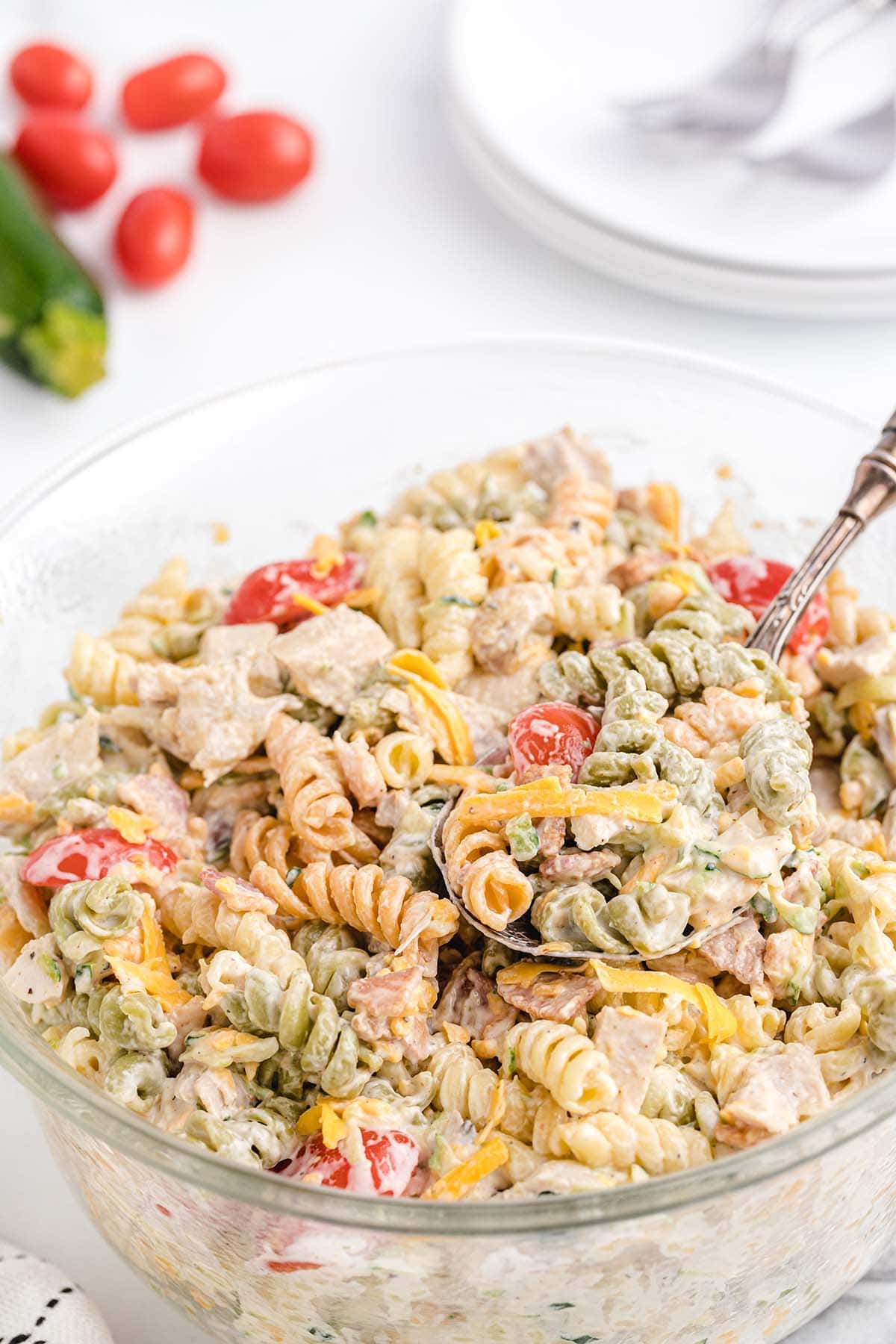chicken bacon ranch pasta salad in a bowl with a spoon. 