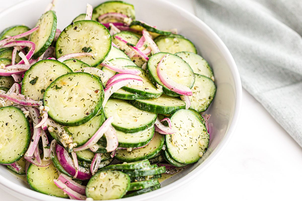 cucumber and red onion salad served in a bowl. 
