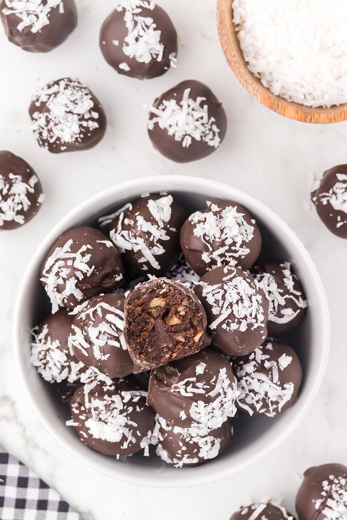a bowl of German Chocolate Truffles with shredded coconut on top.